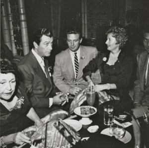 Robert Taylor and Barbara Stanwyck and Robert Stack at a party with Louella Parsons.